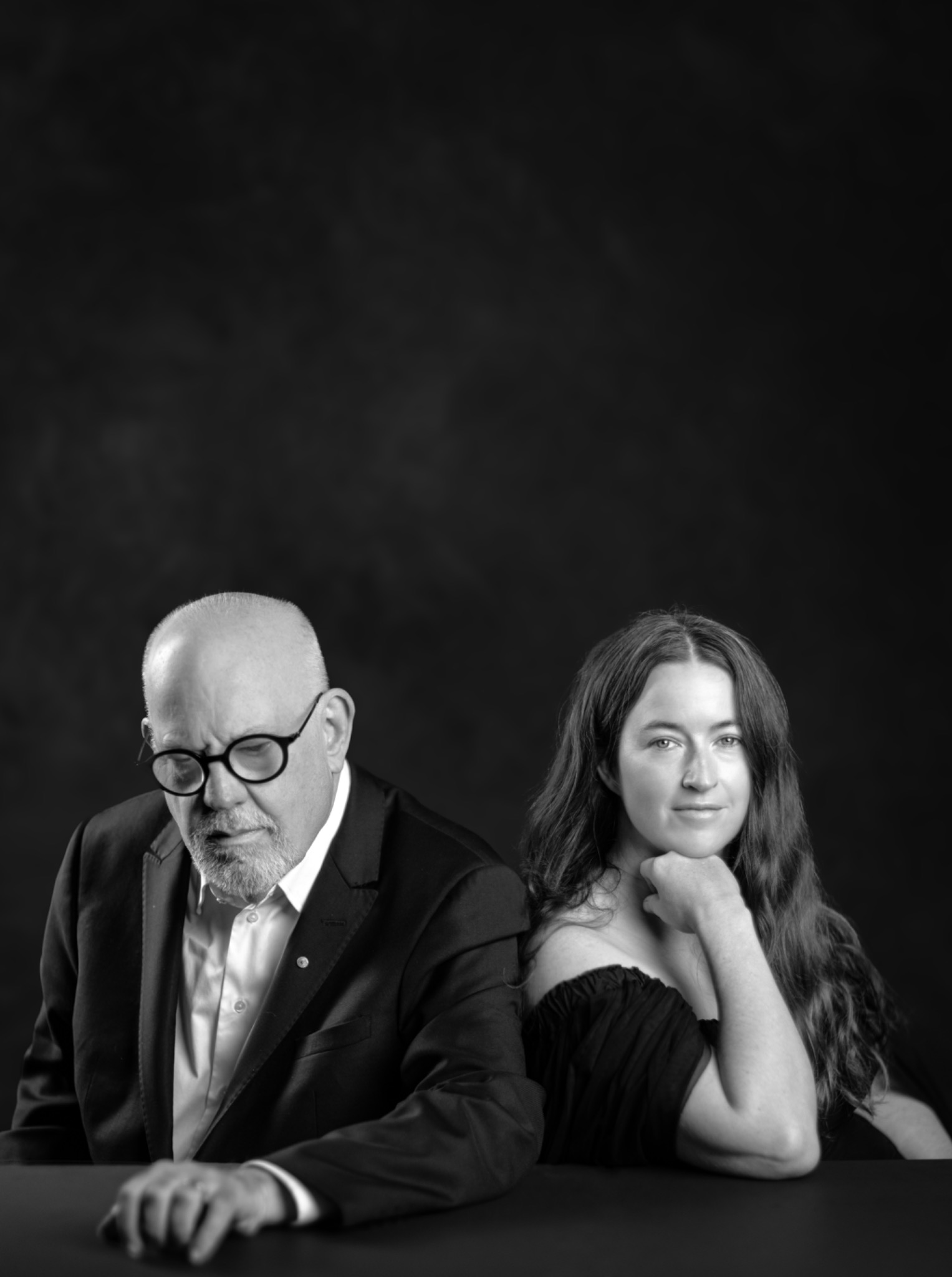 Two people in a black-and-white studio portrait