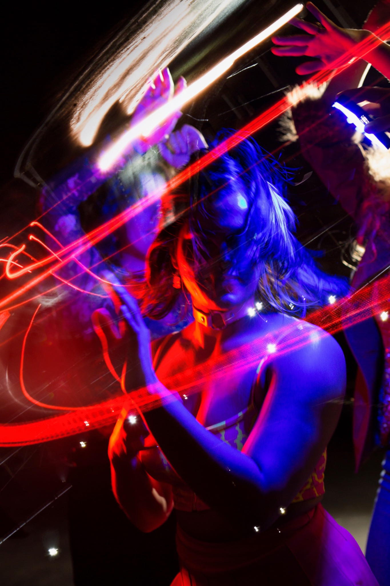A performer lit in saturated red and blue
