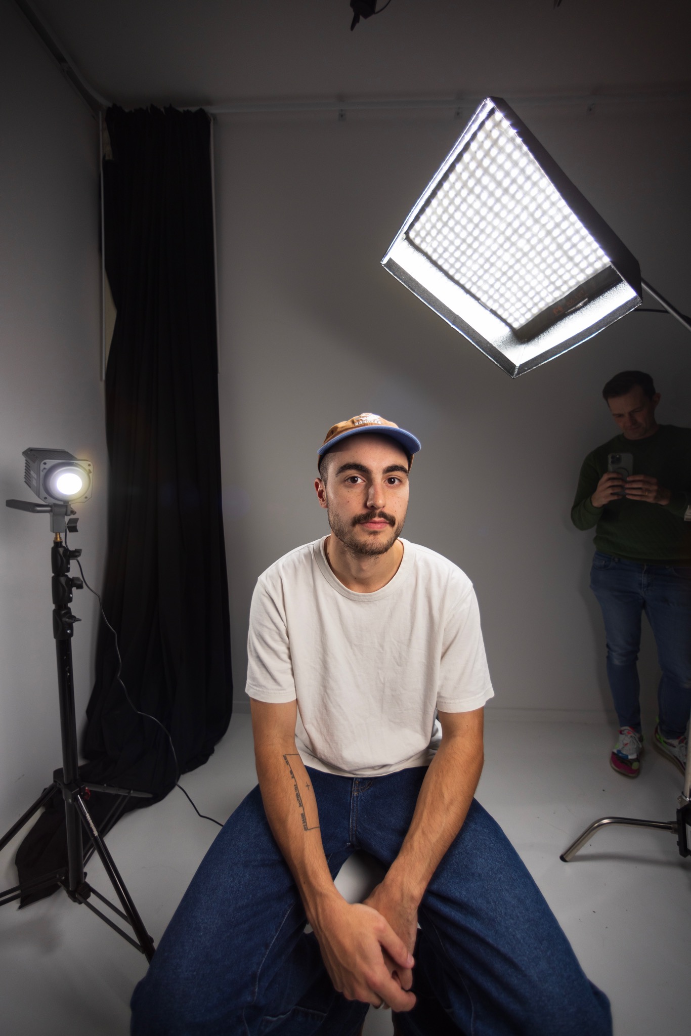 A seated person in a photographic studio