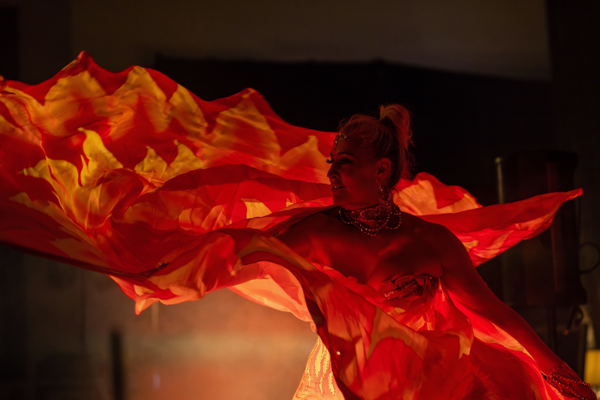 A dancer moving in a red costume