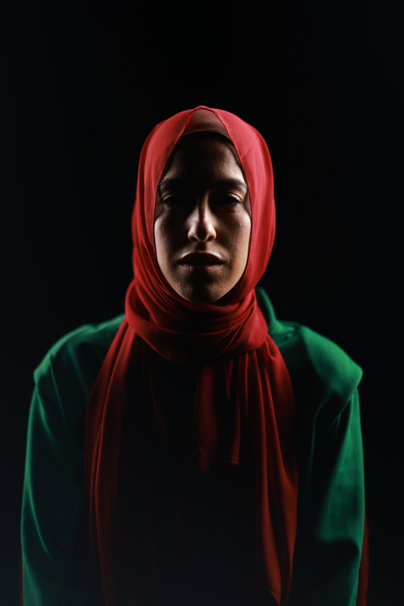 A portrait lit in red and green