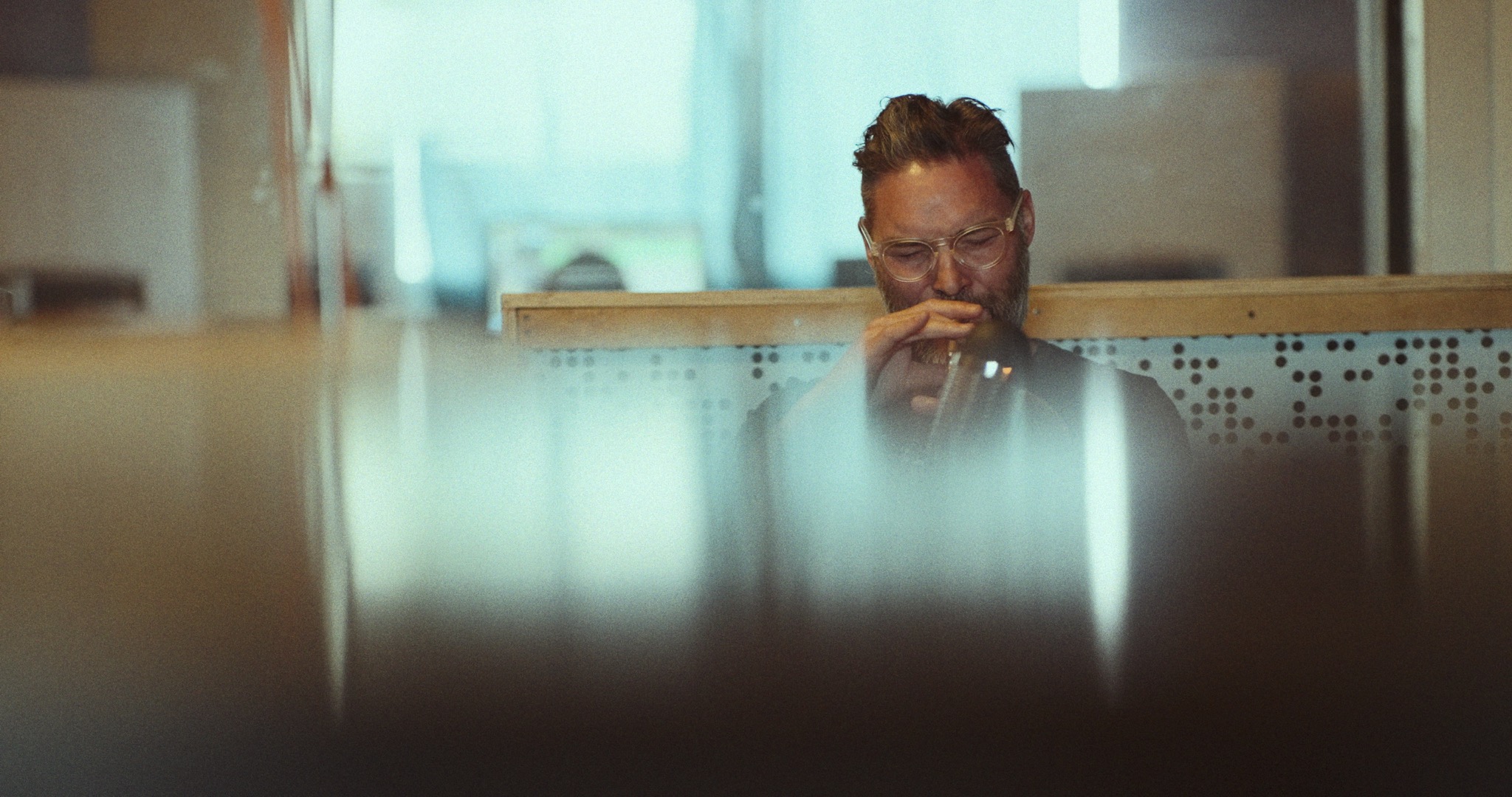A musician seen through an atmospheric interior